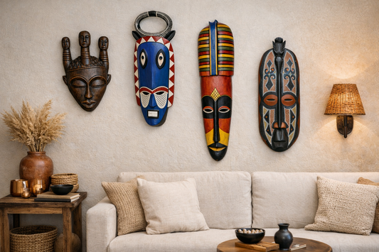Hand-painted West African wood mask with elongated bridge, black and cream geometric patterns, and red accents, styled as modern wall decor.